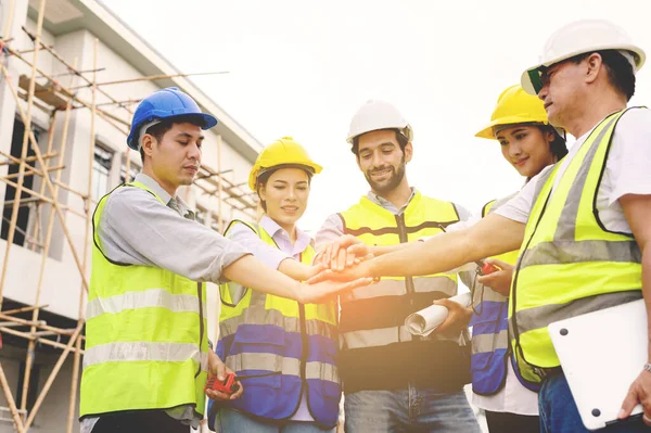 Group Contractors Engineers Formats Safety Vests Helmets Join Hands Work — Foto de Stock