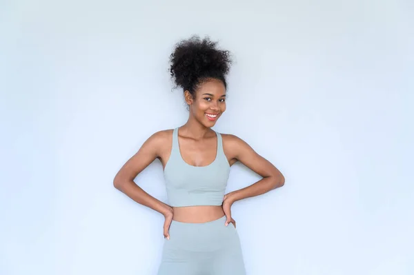 stock image Beautiful young African American girl posing with fitness clothes isolated over white background. Healthy and Fitness concept