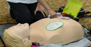 First aid cardiopulmonary resuscitation course using automated external defibrillator device - AED training. selective focus placing electrode