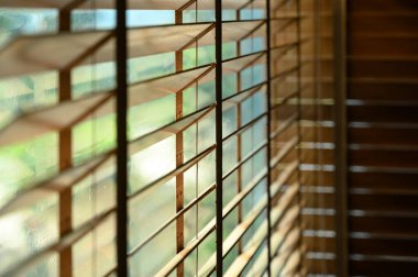 Close-up brown wooden blinds. lighting range control sunlight coming from a window. decoration interior. Modern jalousie