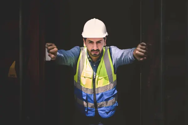 stock image container logistic operators workers wearing yellow helmets and reflection shirts and open containers for inspection and check the condition of containers at warehouse container yard. logistics business import export industry