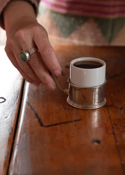 stock image Hand serving coffee a wood table