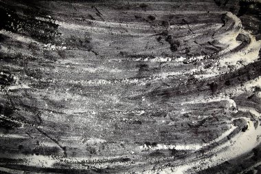 Flour is scattered on a black table. The concept of a bakery for baking homemade bread. Copy space