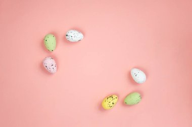 Minimalist composition of easter eggs on a pink background. Copy space.