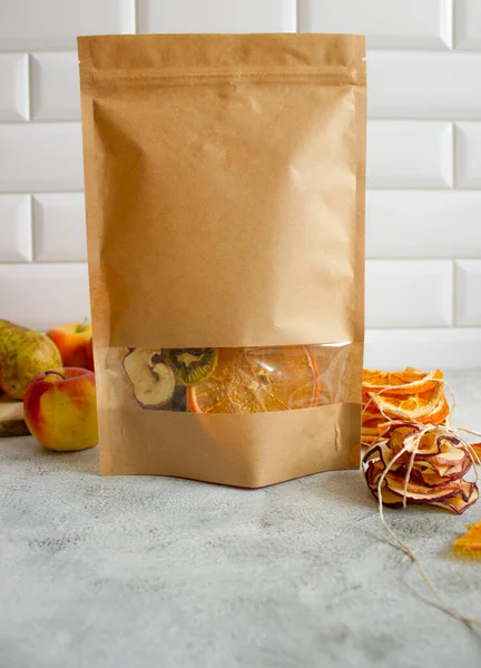 Fruit chips in paper bag. Healthy snack. Copy space