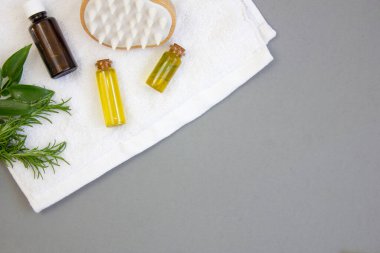 Spa terapisi geçmişi. Kozmetik ürünleri ve saç bakım aksesuarları beyaz bir havluda. Uzayı kopyala Düz yatıyordu.