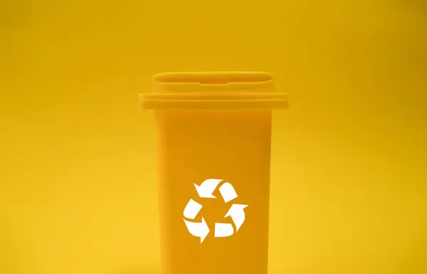 A yellow container with a recycling symbol on a yellow background.