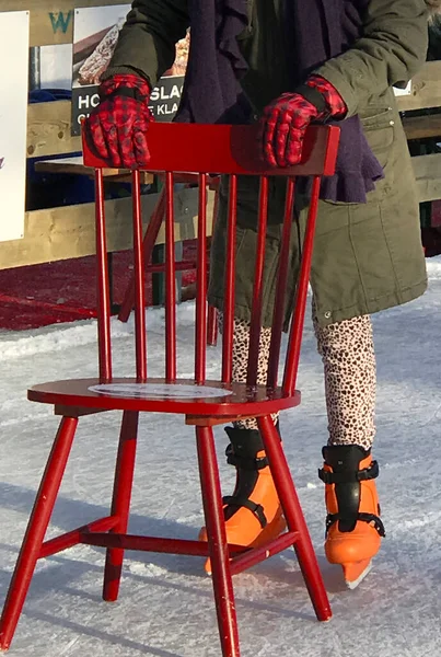 stock image Amersfoort, Netherlands - Jan 6 2017 Ice fun on a temporarily created ice-rink around Christmas. Learning to skate with a red chair