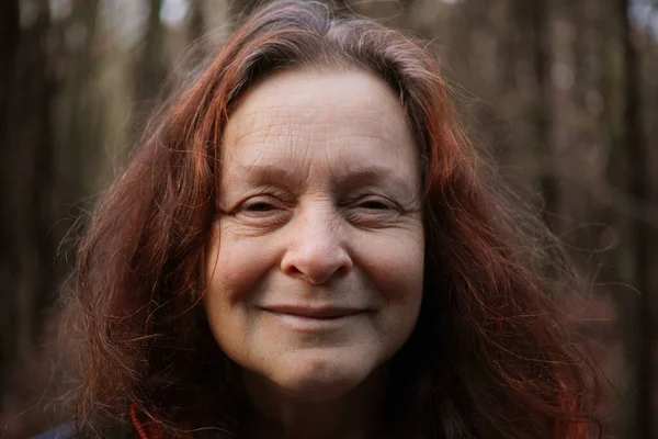 Portrait of a 60 year old smiling woman without make-up