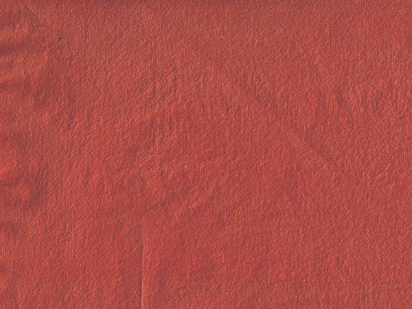 Handmade red paper with paper structure. The color is saturated. Meant as background.