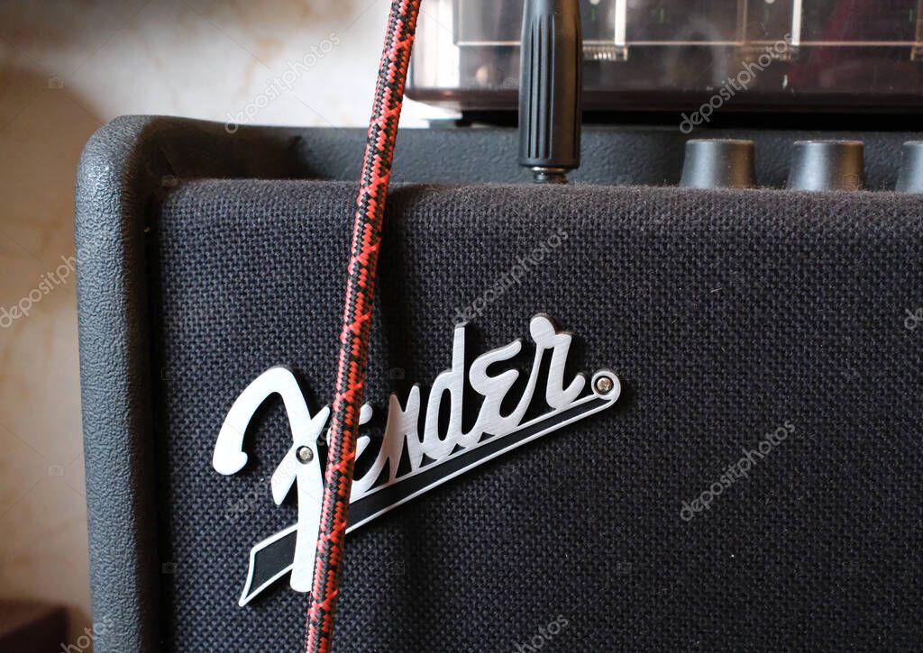 Itterbeck, Germany - Feb 4 2025 Detail of a Fender amplifier with a guitar cable. Fender Logo