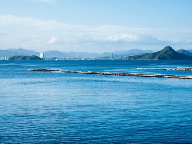 Scenic view of Hiroshima Bay and Hiroshima city skyline from Etajima island in Seto Inland Sea - Hiroshima prefecture, Japan clipart