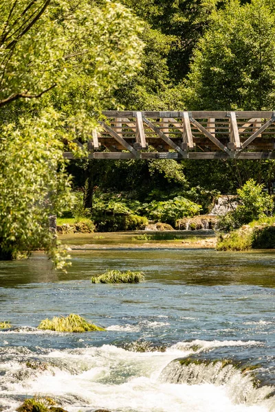 stock image Wooden, pedestrian bridge crossing Slunjcica river in close proximity of Rastoke ethno village, Croatia, famous tourist destination