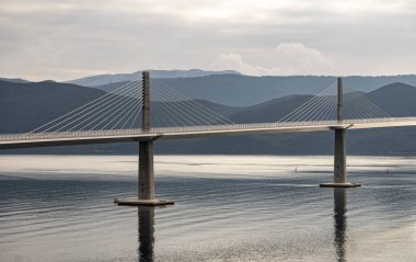 Komarna, Croatia-January 5th, 2023: New, cable-stayed bridge crossing from croatian land to the Peljesac peninsula, connecting the two parts of croatian coast clipart