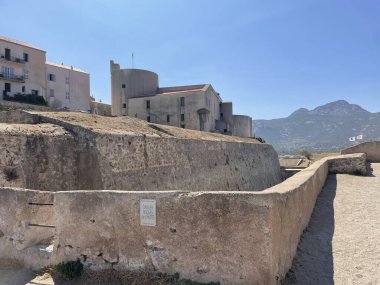 The Citadel of Calvi in Corsica is a striking medieval fortress perched on a rocky promontory above the Mediterranean Sea.  clipart