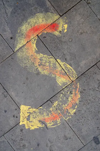 stock image yellow letter S painted on the sidewalk