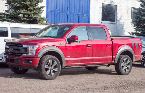 Lviv Ukraine - 03 04 2023: Ford F-150 display red at the dealership. Ford F150 is available  XL, XLT, Lariat, King Ranch, Platinum and Limited models.