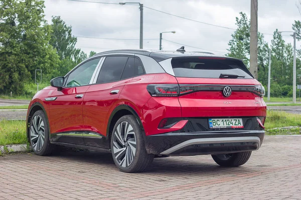 Stock image Lviv Ukraine- 06 11 2023: Red crossover volkswagen electric car in the parking of the city, eco-friendly modern car SUV