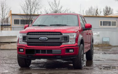Lviv Ukrayna - 12: 24 2022: Ford F-150 bayilikte kırmızı ekran. Ford F150, yağmurlu bir havada park alanında XL, XLT, Lariat, King Ranch, Platinum ve Limited modelleri mevcuttur.