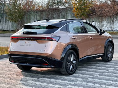 lviv Ukrayna - 11 09 2023: Japon SUV Nissan Aria park yerinde altın renkli, yeni elektrikli bir araba, modern ekonomik bir araba