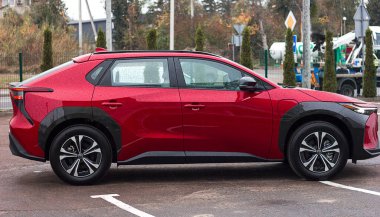 Lviv Ukrayna - 11 05 2023: Toyota bz4x kırmızı renkli elektrikli araba sokakta araba galerisinin önündeki otoparkta