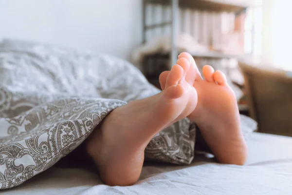 Blurred View Bare Feet Peeking Out Blanket Morning Light Waking — Stock Photo, Image