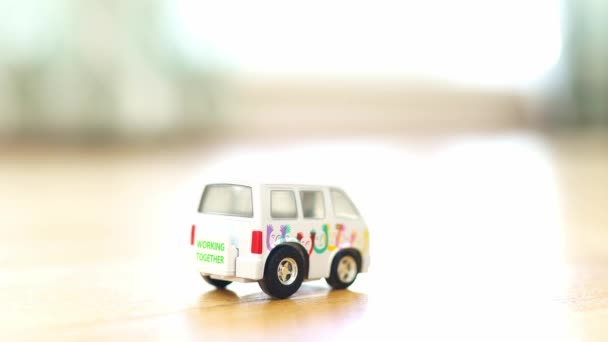 Minivan Toy Riwomans Hand Plays Toy Inertial Car Minibus Inscription — Stock Video