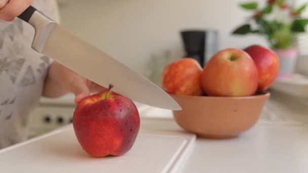 Woman Uses Sharp Kitchen Knife Cut Ripe Large Red Apples — Stock Video