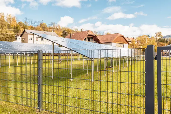 stock image Solar panels in row behind fence on private agricultural farm