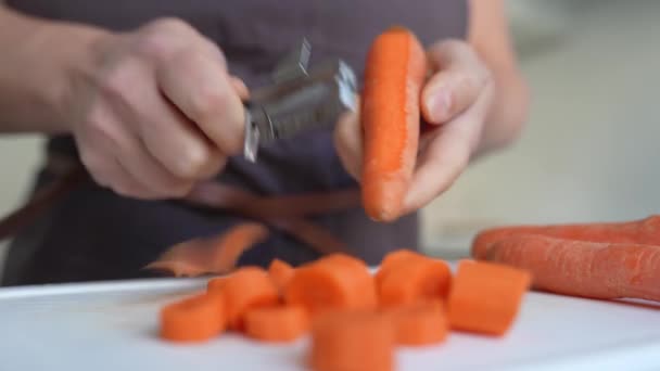 Unrecognizable Figure Woman Brown Apron Peeling Carrots Paring Knife Kitchen — Stock Video
