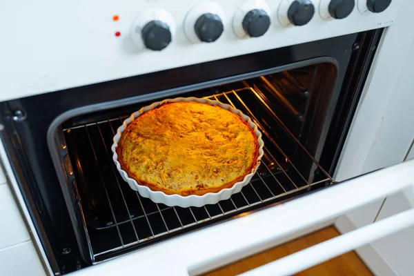 Apple pie with cinnamon shortcrust pastry, in baking dish, baked in oven