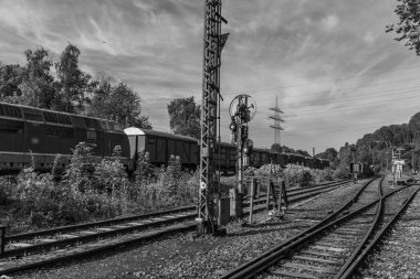 old locomotives and waggons in a historical surrounding clipart