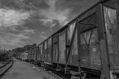 old locomotives and waggons in a historical surrounding clipart