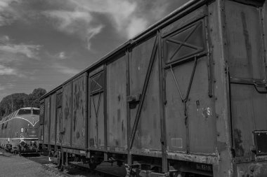 old locomotives and waggons in a historical surrounding clipart