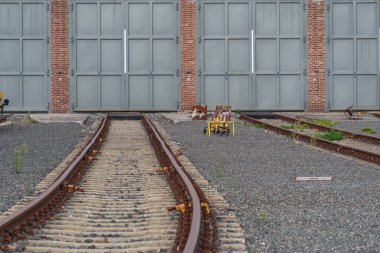 old locomotives and waggons in a historical surrounding clipart