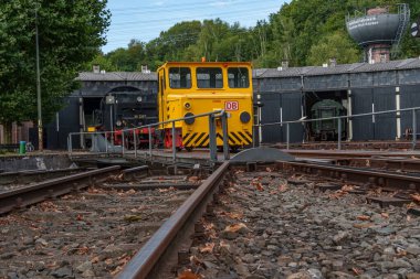 old locomotives and waggons in a historical surrounding clipart