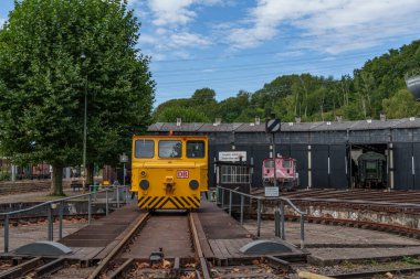 old locomotives and waggons in a historical surrounding clipart