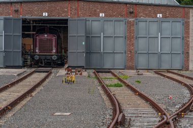 old locomotives and waggons in a historical surrounding clipart