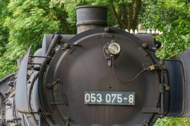 old locomotives and waggons in a historical surrounding clipart