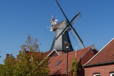 the village of Ditzum at the ems river in germany clipart