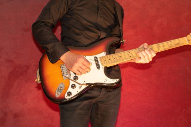 Vaduz, Liechtenstein, September 28, 2022 Musician plays a Fender Stratocaster USA standard electric guitar crafted 1995 in the color sunburst clipart