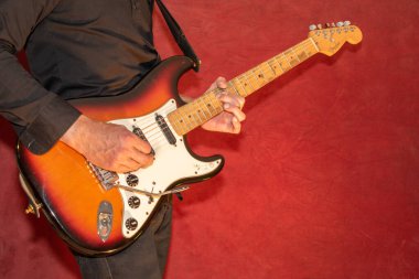 Vaduz, Lihtenştayn, 28 Eylül 2022 Müzisyen Fender Stratocaster ABD standart elektro gitarını çalıyor 1995 yılında güneş patlaması renginde