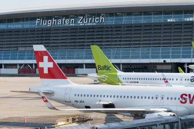 Zurich, Switzerland, January 19, 2023 Swiss Airbus A321-271N Neo and a Baltic Airways Bombardier CS-300 or A220 are parking at the gate