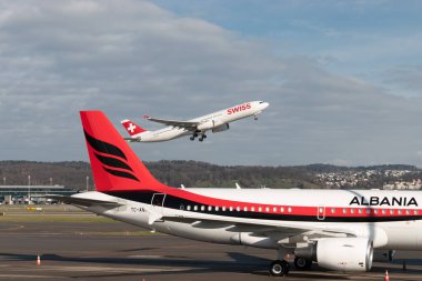 Zurich, Switzerland, January 19, 2023 Swiss Airbus A330-343 aircraft is taking off behind the albanian government Airbus A319-115X-CJ which is parked during the world economic forum
