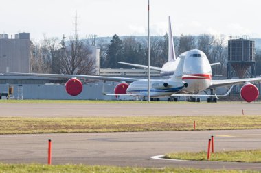 Zurich, Switzerland, January 19, 2023 Dessault Falcon 2000LX and a Korean Boeing 747-8B5 jumbo jet are parking on the apron during the world economic forum in Davos