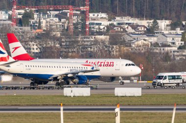 Zurich, Switzerland, January 19, 2023 British airways Embraer E-190 and an Austrian airlines Airbus A320-214 are taxiing to their positions
