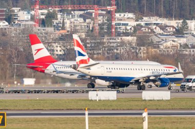 Zurich, Switzerland, January 19, 2023 British airways Embraer E-190 and an Austrian airlines Airbus A320-214 are taxiing to their positions
