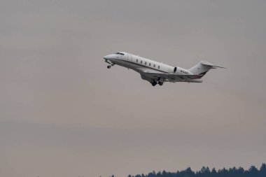 Zurich, Switzerland, January 20, 2023 Bombardier Challenger 350 business aircraft is taking off from runway 28 after the world economic forum in Davos