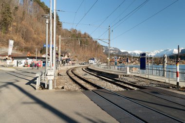 Brienz, Switzerland, February 10, 2023 View along the railway and the train station at the coast of the lake of Brienz
