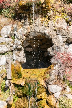 Saint Beatus, Canton Bern, Switzerland, February 12, 2023 Beautiful tiny waterfall flows down along some rocks at the Saint Beatus caves